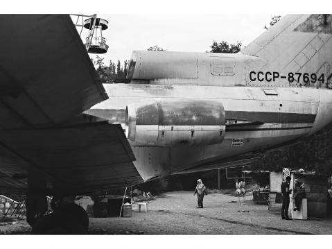 Osh – KYRGYZSTAN 24 July 2015. People pass by an old Russian plane in the entrance to the Park on the shore of the Ak-Buura river.